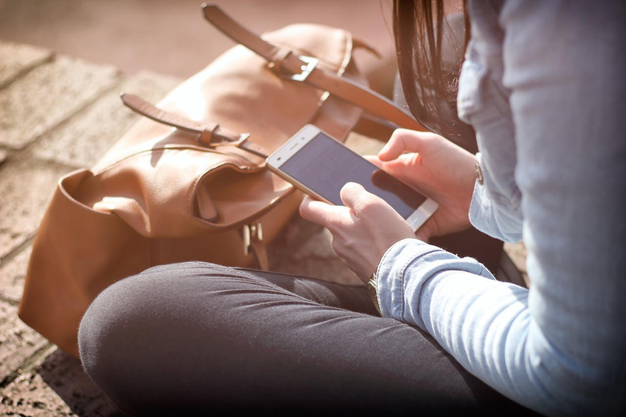 A company owner viewing their Utah County custom website design on their mobile device.